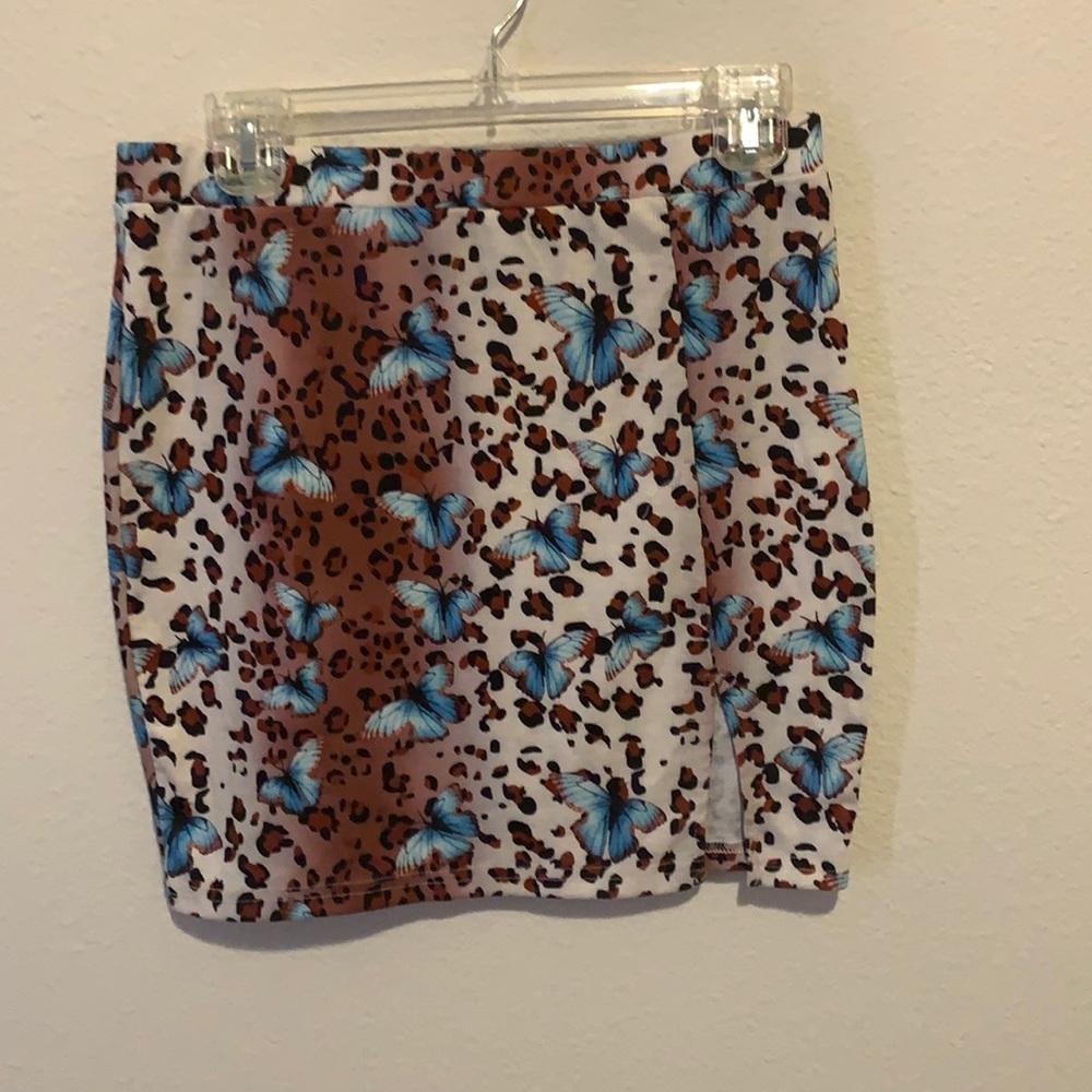 Never worn mixed print mini skirt with split. Very short.